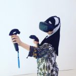 Girl playing Google Tilt Brush on HTC Vive virtual reality (VR) headset on Addictlab Academy booth at Expo Juniors in Palexpo, Geneva, Switzerland.